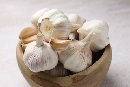 Fresh garlic bulbs on light table, closeup