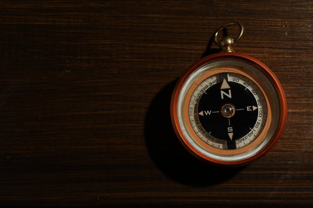 One compass on wooden table, top view. Space for textの写真素材