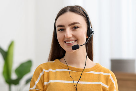 Portrait of smiling hotline operator in headset in office
