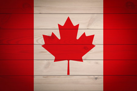 Flag of Canada with maple leaf on wooden surface as backgroundの写真素材