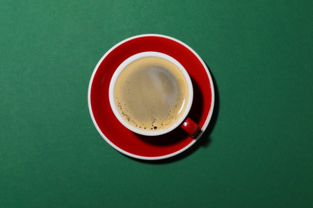 Cup of aromatic coffee on green background, top viewの写真素材