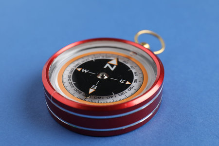 One compass on blue background, closeup viewの写真素材