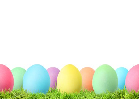 Easter eggs in green grass against white background