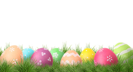 Easter eggs in green grass against white background