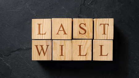 Words made of cubes with letters on black stone table, top view. Banner designの写真素材