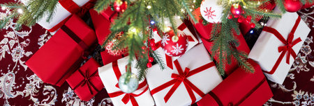 Decorated gifts under Christmas tree at home, above view