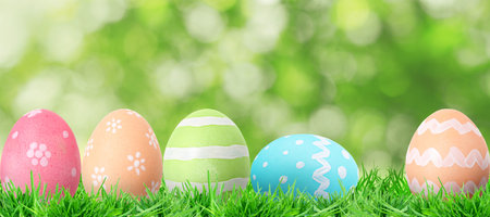 Easter eggs in green grass against blurred background