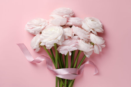 Bouquet of beautiful flowers on pink background, top view
