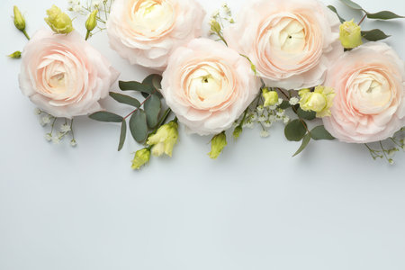 Beautiful ranunculuses and roses on white background, flat lay. Space for text
