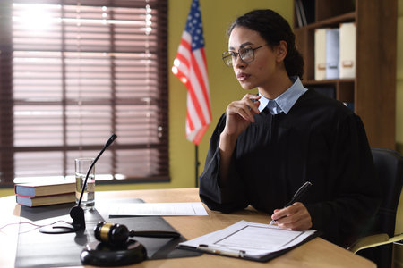 Judge working with document at wooden desk indoors