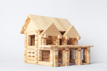 House made of wooden blocks on light backgroundの写真素材