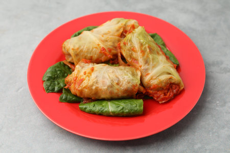 Yummy stuffed cabbage rolls on gray table, closeup