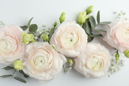 Beautiful ranunculuses and roses on white background, flat lay