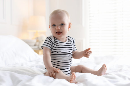 Cute little baby on bed at home