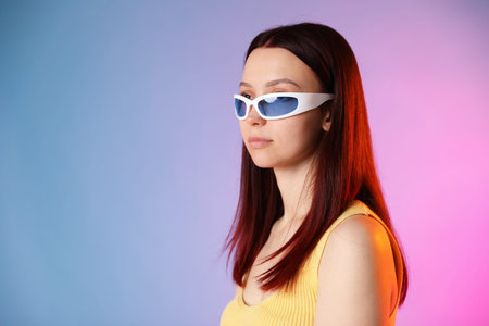 Woman with dyed hair and sunglasses on color gradient background, space for text