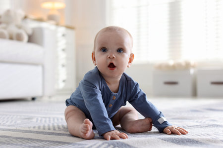 Cute little baby on floor at home