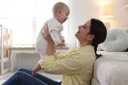 Mother and her cute baby at home