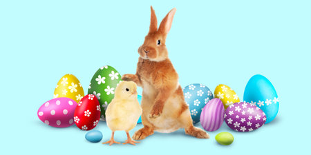 Easter eggs, fluffy bunny and chick on light blue background. Banner design