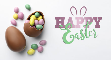 Happy Easter greeting poster with chocolate eggs and candies on white background, top view