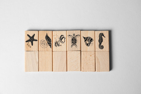 Mahjong tiles with sea animals on light background, top view