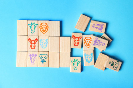 Children's tiles with animals on light blue background, flat lay