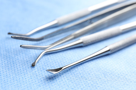 Many different dental tools on medical napkin, closeup