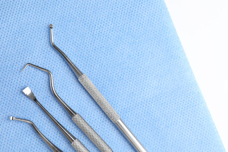 Many different dental tools and medical napkin on white table, flat lay. Space for textの写真素材