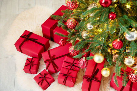 Many gift boxes under Christmas tree indoorsの写真素材