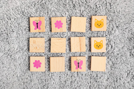 Child's toy. Wooden tiles with pictures on carpet, flat layの写真素材