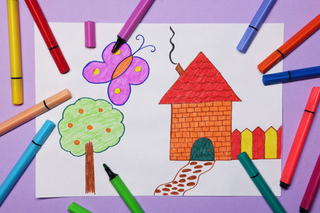 Child's drawing and felt-tip pens on violet background, flat lay