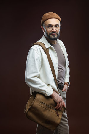 Handsome man on dark brown backgroundの写真素材