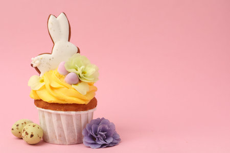 Tasty cupcake with Easter decor on pink background, closeup. Space for text