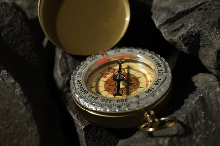 One vintage compass on stones, closeup view