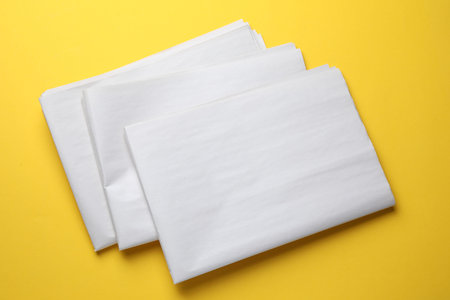 Newspapers on yellow background, top view. Mockup for design