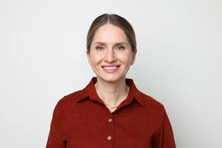 Portrait of beautiful woman on light grey background