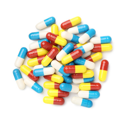 Pile of different pills isolated on white, top view
