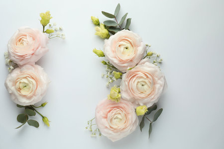 Beautiful ranunculuses and roses on white background, flat lay. Space for text
