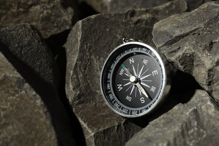 One modern compass on stones, closeup viewの写真素材