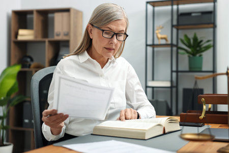 Notary working at wooden desk in officeの写真素材