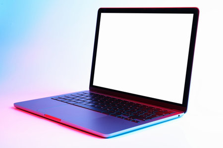 Modern laptop with blank screen in neon lights on white backgroundの写真素材