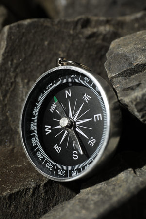 One modern compass on stones, closeup view