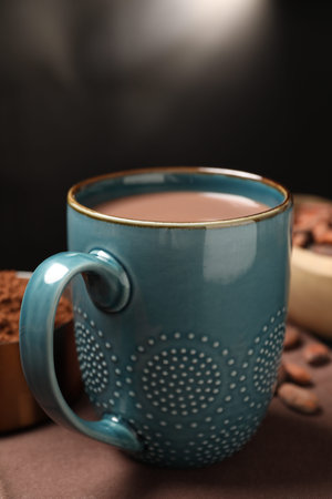 Delicious cocoa drink in mug on brown table, closeupの写真素材