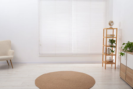 Shelving unit with different decor, armchair and cabinet indoors, space for text. Interior designの写真素材