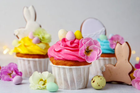 Tasty cupcakes with Easter decor on light grey table, closeup