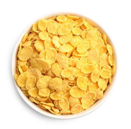 Tasty corn flakes in bowl isolated on white, top view