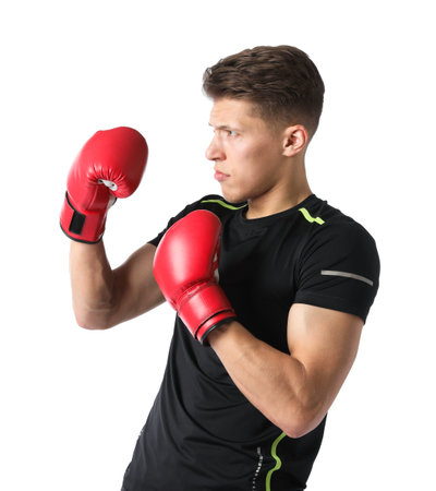 Athletic man in red boxing gloves fighting on white background