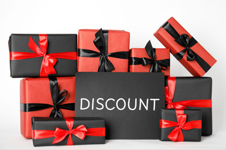 Discount card and gift boxes on white background