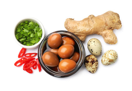 Pickled quail eggs in glass jar and ingredients isolated on white, top viewの写真素材