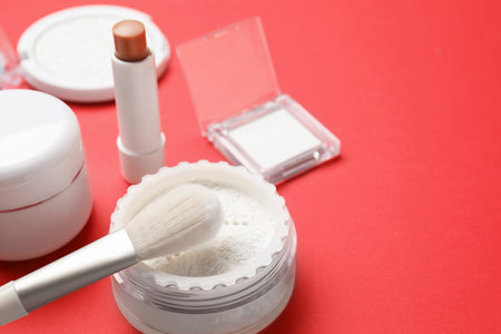 Many different cosmetic products on red background, closeup. Space for text