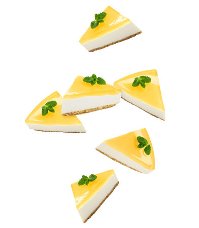 Pieces of tasty cheesecake falling on white background. Yummy dessert